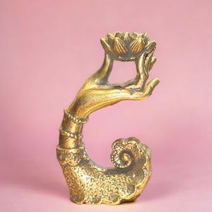 Hand holding lotus flower incense holder